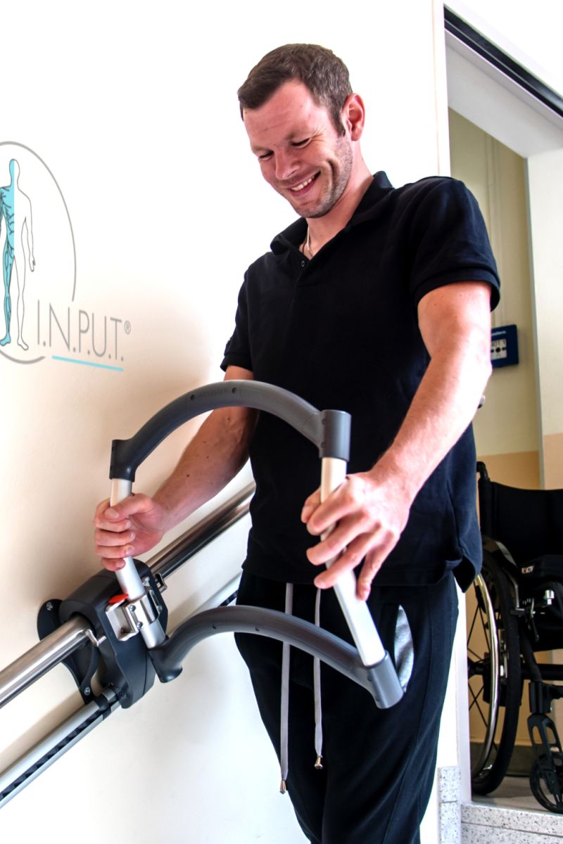 Patient suffering from incomplete paraplegia and spinal cord injury training in stairs with the AssiStep during rehabilitation